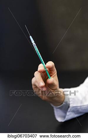 A hand holds a syringe for vaccine against COVID-19 at a vaccination center in Erding, Bavaria, Germany, Europe View Large Photo Image Stock Photo - A hand holds a syringe for vaccine against COVID-19 at a vaccination center in Erding, Bavaria, Germany, Europe. Fotosearch
