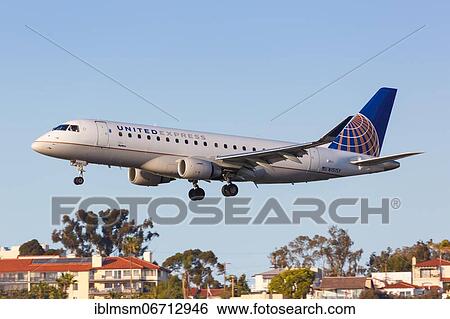 Stock Photograph - A United Express Skywest Embraer ERJ 175 aircraft with registration number N151SY lands at San Diego Airport, U. S. Fotosearch