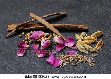 Stock Image - Advieh, spice mix, Persian cuisine, rose buds, rose petals, cardamom, cinnamon, cumin powder, cumin. Fotosearch