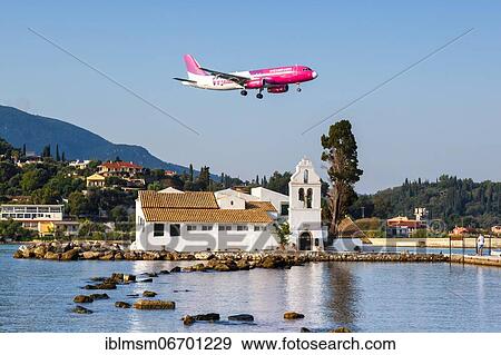 An Airbus A320 aircraft of Wizzair with registration number HA-LYO at Corfu Airport (CFU), Corfu, Greece, Europe View Large Photo Image Stock Photo - An Airbus A320 aircraft of Wizzair with registration number HA-LYO at Corfu Airport (CFU), Corfu, Greece, Europe. Fotosearch