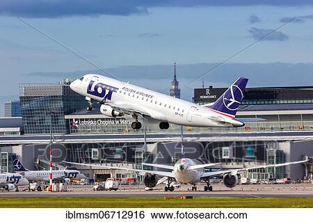 Stock Photograph - An Embraer 175 of LOT Polskie Linie Lotnicze with the registration SP-LIC takes off from Warsaw Airport, Poland, Europe. Fotosearch