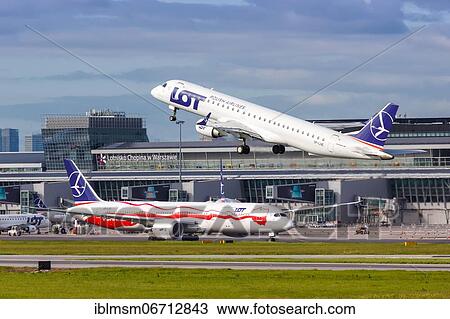 Stock Image - An Embraer 195 of LOT Polskie Linie Lotnicze with the registration SP-LNE takes off from Warsaw Airport, Poland, Europe. Fotosearch