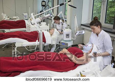 Stock Photo - Application of the blue face pack with azulene in practical lessons. Training as a beautician at the vocational school, Düsseldorf, North Rhine-Westphalia, Germany, Europe. Fotosearch