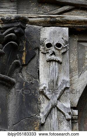 Stock Image - Architectural decoration on the facade of the charnel house, skull, skull, bones, charnel house, old cemetery, Aitre St. Maclou, Rouen, Normandy, France, Europe. Fotosearch
