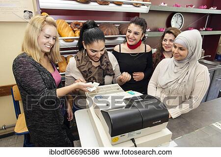 Bakery saleswomen during their practical training at the teaching counter in the vocational school, Düsseldorf, North Rhine-Westphalia, Germany, Europe View Large Photo Image Stock Photograph - Bakery saleswomen during their practical training at the teaching counter in the vocational school, Düsseldorf, North Rhine-Westphalia, Germany, Europe. Fotosearch