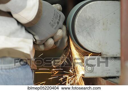 Blacksmith at work, grinding horseshoes View Large Photo Image Picture - Blacksmith at work, grinding horseshoes. Fotosearch