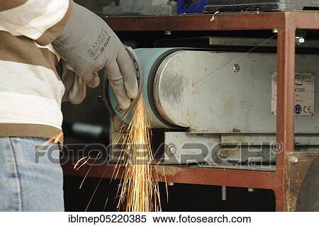 Stock Photography - Blacksmith at work, grinding horseshoes. Fotosearch