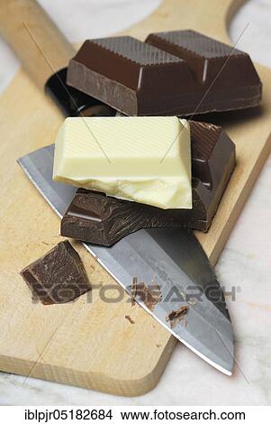 Block chocolate in pieces, on cake board, chocolate, milk chocolate, milk chocolate, cake glaze, couverture, knife View Large Photo Image Picture - Block chocolate in pieces, on cake board, chocolate, milk chocolate, milk chocolate, cake glaze, couverture, knife. Fotosearch