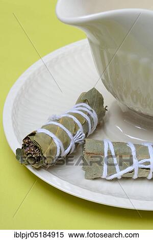 Stock Photography - Bouquet garni, herb bouquet of bay leaf, thyme, oregano and savory. Fotosearch