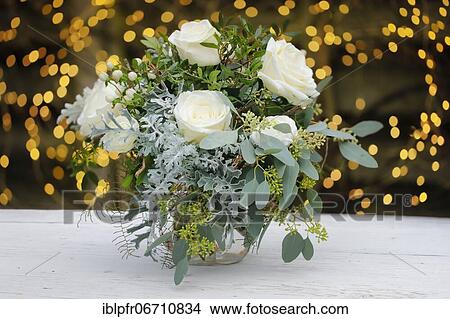 Bouquet of flowers on wooden plate in front of fairy lights View Large Photo Image Picture - Bouquet of flowers on wooden plate in front of fairy lights. Fotosearch