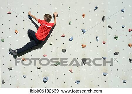Stock Photo - Boy climbs climbing wall, climbing sport, climber. Fotosearch