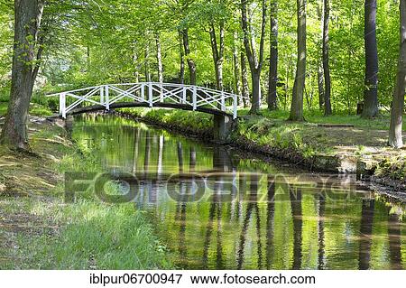 Bridge over the moat in the park of Hermsdorf Castle, Ottendorf-Okrilla, Saxony, Germany, Europe View Large Photo Image Stock Photo - Bridge over the moat in the park of Hermsdorf Castle, Ottendorf-Okrilla, Saxony, Germany, Europe. Fotosearch