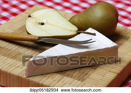 Picture - Brie, brie cheese, pear, pear half, knife, soft cheese, cheese knife. Fotosearch