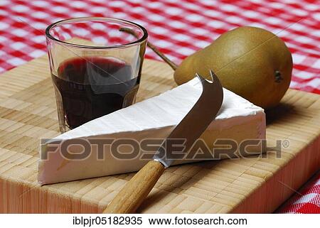 Stock Photography - Brie, brie cheese, pear, pear half, glass of red wine, knife, soft cheese, cheese knife. Fotosearch