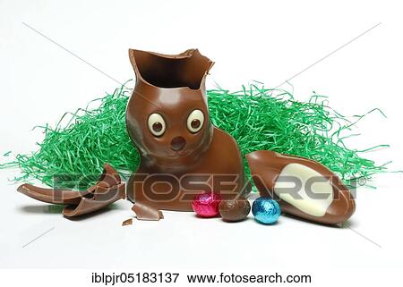Stock Photo - Broken chocolate Easter bunny and chocolate eggs, Easter bunny. Fotosearch
