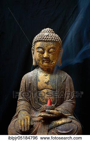 Buddha with burning incense cone View Large Photo Image Stock Photograph - Buddha with burning incense cone. Fotosearch