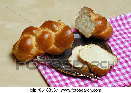 Stock Photo - Butter plait on plate, baked goods, Swiss white bread, bread. Fotosearch