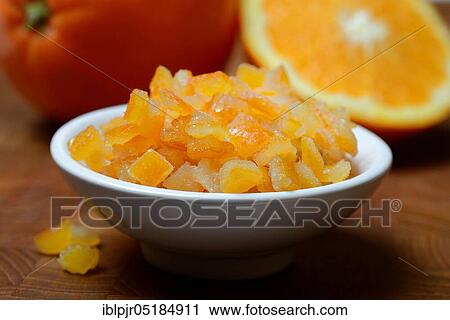 Stock Image - Candied orange peel, candied orange peel in peel, orange peel cubes and oranges, orange. Fotosearch