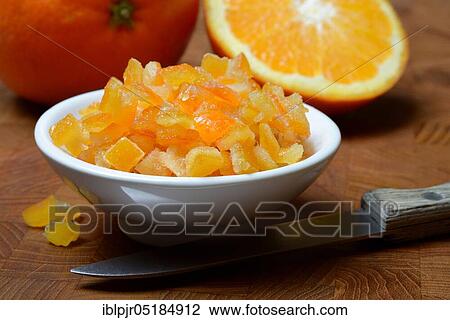 Stock Image - Candied orange peel, candied orange peel in peel, orange peel cubes and oranges, orange. Fotosearch