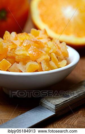 Stock Image - Candied orange peel, candied orange peel in peel, orange peel cubes and oranges, orange. Fotosearch