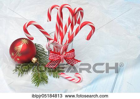 Candy canes in glass and Christmas tree ball with fir branch, red-white View Large Photo Image Stock Image - Candy canes in glass and Christmas tree ball with fir branch, red-white. Fotosearch