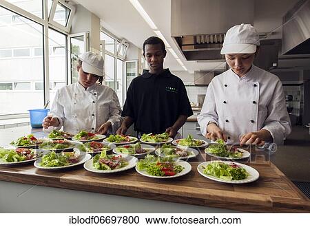 Canteen kitchen in a vocational college in Düsseldorf, trainees manage the school's catering as part of their training, trainees prepare salad plates, Düsseldorf, Germany, Europe View Large Photo Image Stock Image - Canteen kitchen in a vocational college in Düsseldorf, trainees manage the school's catering as part of their training, trainees prepare salad plates, Düsseldorf, Germany, Europe. Fotosearch