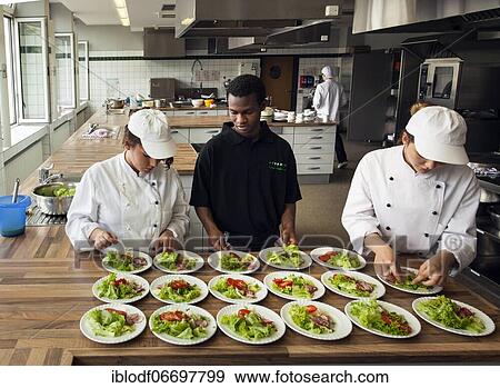 Canteen kitchen in a vocational college in Düsseldorf, trainees manage the school's catering as part of their training, trainees prepare salad plates, Düsseldorf, Germany, Europe View Large Photo Image Stock Photo - Canteen kitchen in a vocational college in Düsseldorf, trainees manage the school's catering as part of their training, trainees prepare salad plates, Düsseldorf, Germany, Europe. Fotosearch