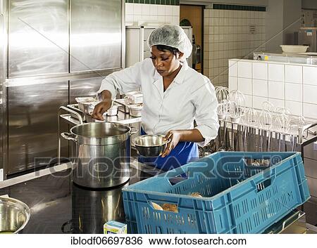 Stock Photograph - Canteen kitchen in a vocational college in Düsseldorf, trainees manage the school's catering as part of their training, practical lessons in the canteen kitchen, Düsseldorf, Germany, Europe. Fotosearch