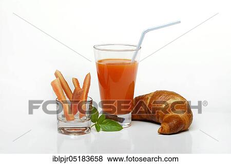 Stock Photo - Carrot juice, carrot juice in glass, carrot sticks and croissant, vegetable juice, carrot, breakfast, carrot juice, carrot juice. Fotosearch