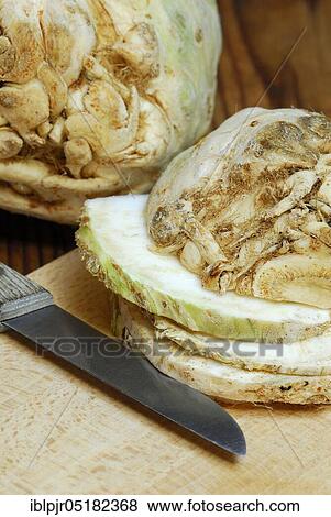 Stock Photo - Celery (Apium graveolens) tubers and s lices, knives. Fotosearch