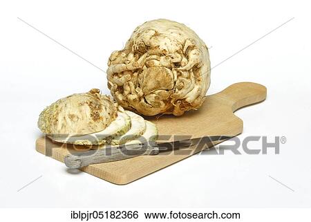Stock Photograph - Celery (Apium graveolens) tubers and s lices, knives. Fotosearch