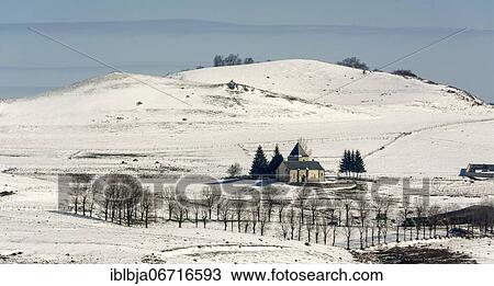 Stock Image - Church of Saint-Alyre-ès-Montagne in winter, Puy de Dome department, Cezallier massif, Auvergne-Rhone-Alpes, France, Europe. Fotosearch