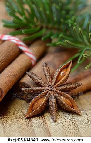 Stock Image - Cinnamonsticks and star anise with Christmas decoration, stick, star anise, aniseed. Fotosearch