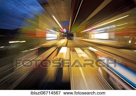 Stock Photo - Colorful, semi-abstract light traces from a moving suspension railway in the evening, Wuppertal, Bergisches Land, North Rhine-Westphalia, Germany, Europe. Fotosearch