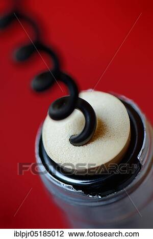 Stock Image - Corkscrew and wine bottle, corks, plastic corks, wine corks, bottle corks. Fotosearch