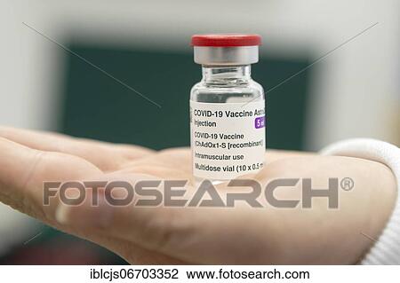 Stock Image - Covid-19 vaccination, vaccine from AstraZeneca, ampoule on open palm, Bergisches Land, North Rhine-Westphalia, Germany, Europe. Fotosearch