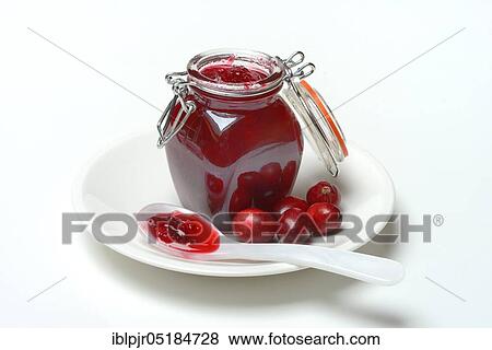 Stock Photo - Cranberry jam in glass and spoon ( Vaccinium macrocarpon). Fotosearch