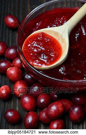Stock Image - Cranberry ( Vaccinium macrocarpon) and compote in glass bowl. Fotosearch