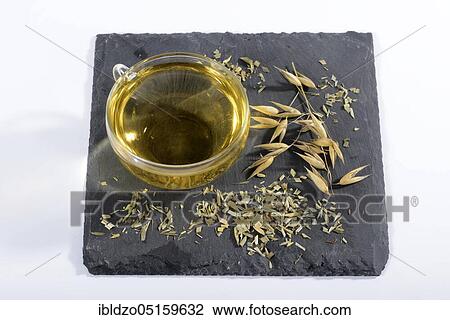Stock Image - Cup oat straw tea (Avena sativa), oats. Fotosearch
