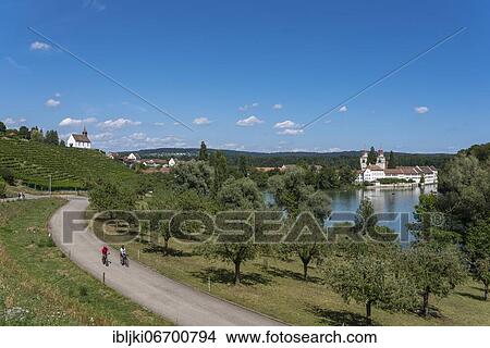 Cyclist, Rhine, Rheinau Monastery Island and Saint Nicholas Mountain Church, Rheinau, Canton Zurich, Switzerland, Europe View Large Photo Image Picture - Cyclist, Rhine, Rheinau Monastery Island and Saint Nicholas Mountain Church, Rheinau, Canton Zurich, Switzerland, Europe. Fotosearch