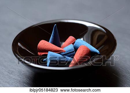 Stock Image - Different incense cones in bowl, incense candle. Fotosearch