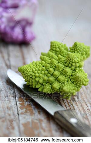 Stock Photograph - Different varieties Cauliflower ( Braßica oleracea var. botrytis) with knife, Romanesco. Fotosearch