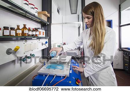 Stock Image - Doctoral student during her research work on a small film drawing bench in the laboratory at the Institute for Pharmaceutical Technology and Biopharmacy at the Heinrich-Heine-University Düsseldorf, North Rhine-Westphalia, Germany, Europe. Fotosearch