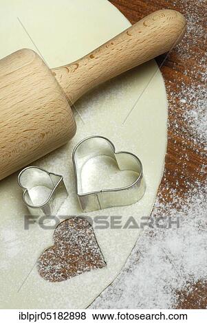 Stock Photo - Dough, cookie dough, cookie dough, cookie cutter, cookie, biscuits, cookie cutter, heart shape, heart-shaped, dough roll, pastry, bakery products, baking, cookies. Fotosearch
