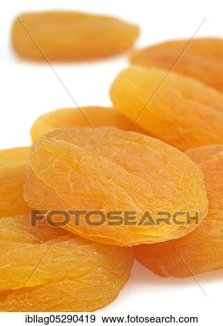 Stock Photo - Dried apricots (Prunus armeniaca) against white background. Fotosearch