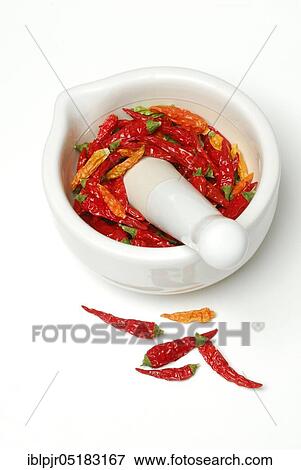Stock Photo - Dried chilli peppers in grating bowl, cayenne, paprika, chilli pepper, hot peppers, chilli peppers, tabasco, piri-piri, mortar. Fotosearch