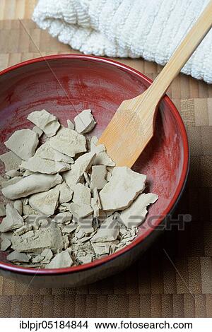 Picture - Dried healing clay in bowl, red clay, clay, healing clay powder. Fotosearch