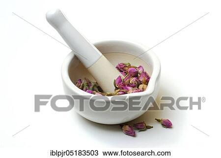 Stock Image - Dried rose buds are crushed in mortar, grated, bud, bud. Fotosearch