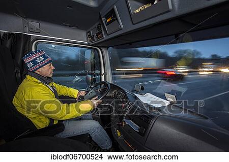 Driving a truck at dawn in winter with poor visibility and road conditions View Large Photo Image Picture - Driving a truck at dawn in winter with poor visibility and road conditions. Fotosearch