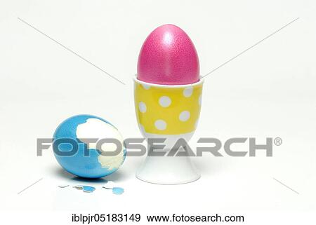 Stock Photo - Easter egg in egg cup, coloured eggs, hen's egg. Fotosearch